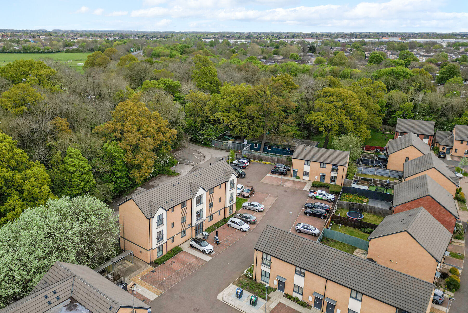 Block C and the car park, backed by woodland