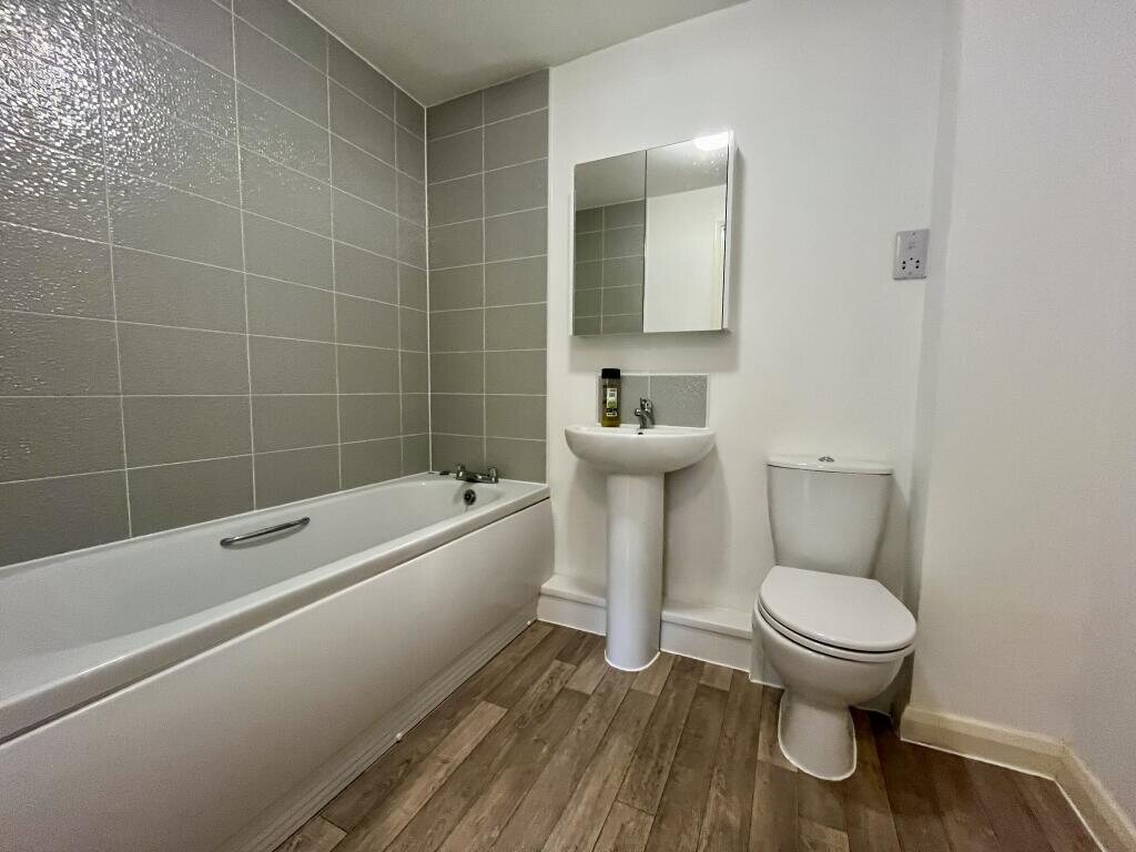 Family bathroom with mirrored cabinet