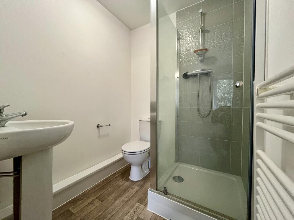 En-suite shower room with heated towel rail